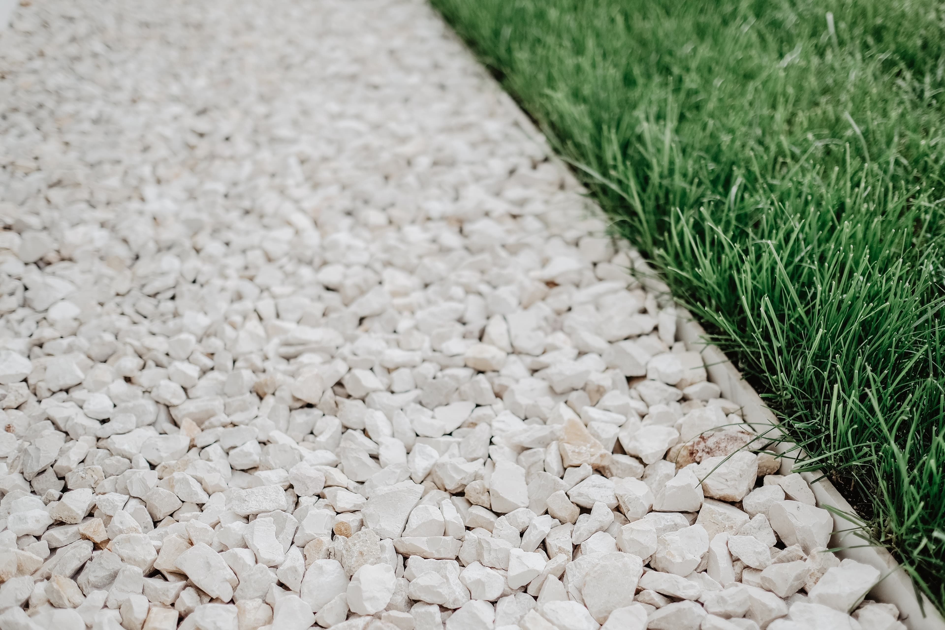 Neatly laid gravel beside green lawn